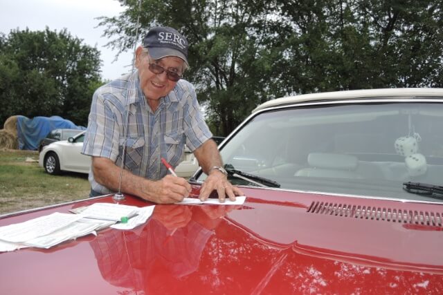 Seller signing the bill of sale after the inspection and test drive. 