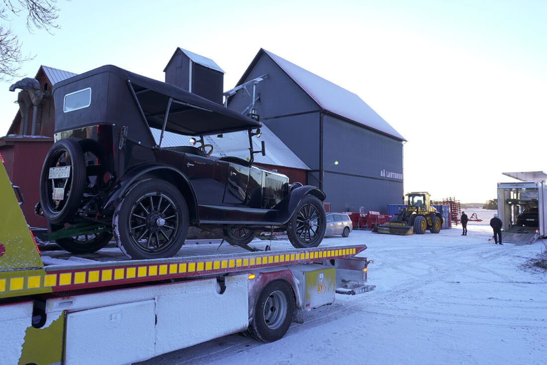 Classic car being loaded onto an enclosed trailer
